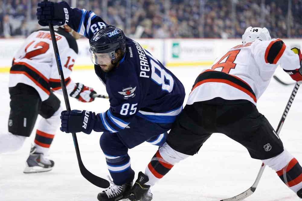 John Woods / The Canadian Press
Winnipeg Jets' Mathieu Perreault (85) gets around New Jersey Devils' Adam Henrique (14) during the second period of Tuesday's game in Winnipeg. The Jets won 3-1.