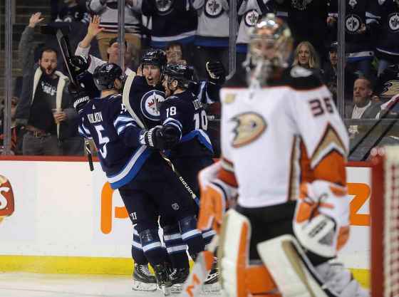 TREVOR HAGAN / THE CANADIAN PRESSWinnipeg Jets' Dmitry Kulikov (5), Patrik Laine (29) and Bryan Little (18) celebrate after Laine scored on Anaheim Ducks goaltender John Gibson (36) during second period NHL hockey action in Winnipeg, Sunday, January 13, 2019.