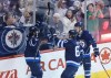 John Woods / The Canadian Press files
Winnipeg Jets' Michael Frolik (67) and Mark Scheifele (55) and Drew Stafford (12) celebrate Stafford's goal against Calgary Flames goaltender Joni Ortio (37) during first period NHL action in Winnipeg Saturday. An injury kept Mathieu Perrault out of Saturday's game and whether he plays Thursday in Anaheim will be a game-time decision, coach Paul Maurice said.