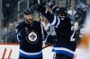 JOHN WOODS / The Canadian Press
Winnipeg Jets' Bryan Little, left, celebrates his goal with teammate Blake Wheeler (26) against the Calgary Flames during the second period.