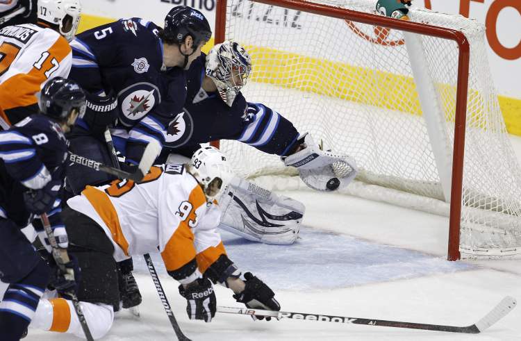TREVOR HAGAN / THE CANADIAN PRESS ARCHIVES
Winnipeg goaltender Ondrej Pavelec made his share of spectacular saves last season. None was better than this rob-job on Philly’s Jakub Voracek. Everyone is still waiting for his first big stop since last spring.