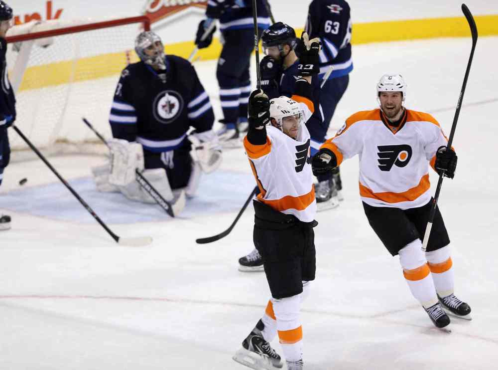 TREVOR HAGAN / THE CANADIAN PRESS FILES
Philadelphia Flyers Jakub Voracek (left) and Nicklas Grossmann celebrate after Voracek scored 10 seconds into overtime at the MTS Centre Sunday night.