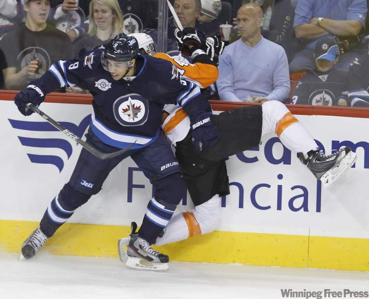 Trevor Hagan / The Canadian Press
Winnipeg Jets' Evander Kane hits Philadelphia Flyers' Tomas Fleischmann during the first period Saturday at the MTS Centre.