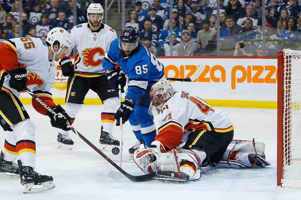 JOHN WOODS / THE CANADIAN PRESS
Winnipeg Jets' Mathieu Perreault (85) scores on Calgary Flames goaltender Mike Smith (41) during second period NHL action in Winnipeg on Saturday, March 16, 2019.