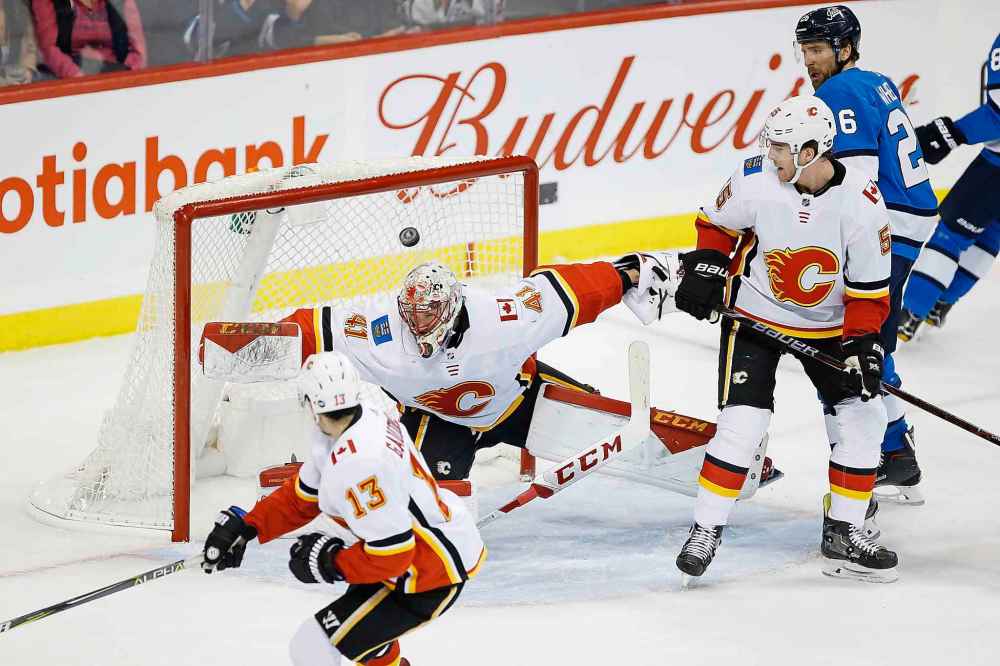 JOHN WOODS / THE CANADIAN PRESS
Winnipeg Jets' Ben Chiarot (7) shot is saved by Calgary Flames goaltender Mike Smith (41) during first period NHL action.
