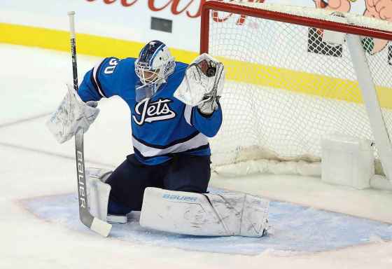TREVOR HAGAN / THE CANADIAN PRESSWinnipeg Jets goaltender Laurent Brossoit (30) makes a glove save against the Carolina Hurricanes during first period NHL hockey action in Winnipeg, Sunday, October 14, 2018.