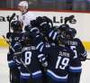 Trevor Hagan / The Canadian Press
The Winnipeg Jets' mob Evander Kane (9) after he scored the game-winning overtime goal against the New York Islanders on Sunday.