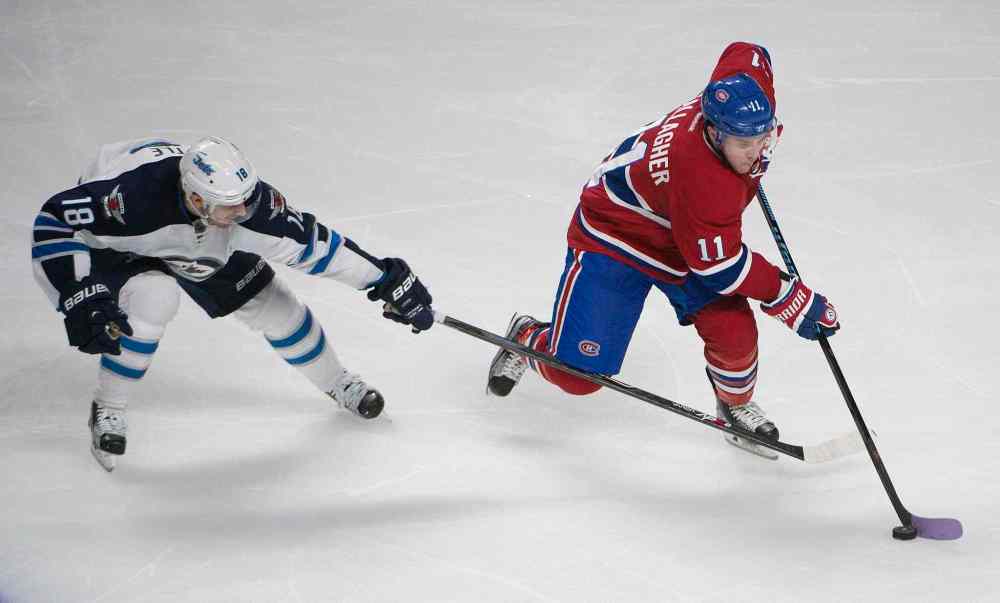 Peter McCabe / THE CANADIAN PRESS
Winnipeg Jets' Bryan Little, left, reaches for the puck as Montreal Canadiens' Brendan Gallagher skates around him during third period NHL action Sunday November 1, 2015 in Montreal.