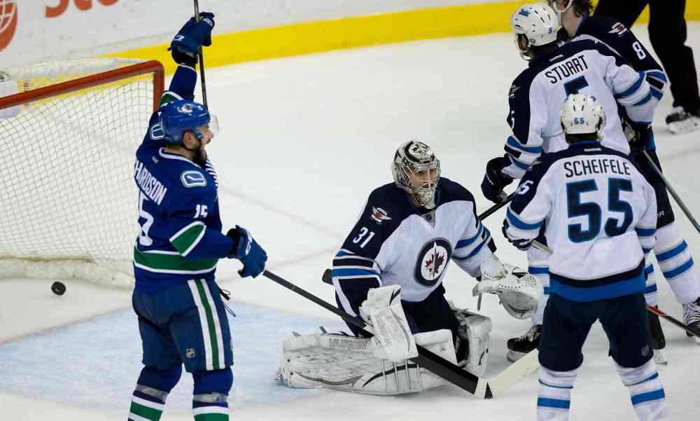 Darryl Dyck / The Canadian Press
Canucks' right-winger Brad Richardson (left) celebrates Chris Tanev's third-period game-winning goal against the Jets Sunday night in Vancouver.