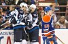 Jason Franson / THE CANADIAN PRESS
Winnipeg Jets' Blake Wheeler (26), Drew Stafford (12) and Mark Scheifele (55) celebrate a goal as Edmonton Oilers' Andrew Miller (58) skates past during first period NHL hockey action in Edmonton, Alta., on Monday.