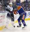 JASON FRANSON / THE CANADIAN PRESS Files
Winnipeg Jets' Andrew Copp (51) is checked by Edmonton Oilers' Griffin Reinhart (8) during first period NHL pre-season action in Edmonton, Alta., on Wednesday. The Jets host the Oilers tonight at the MTS Centre.