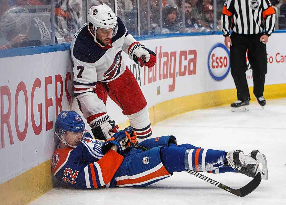 JASON FRANSON / THE CANADIAN PRESS
Winnipeg Jets' Ben Chiarot (7) checks Edmonton Oilers' Tobias Rieder (22) during the second period.