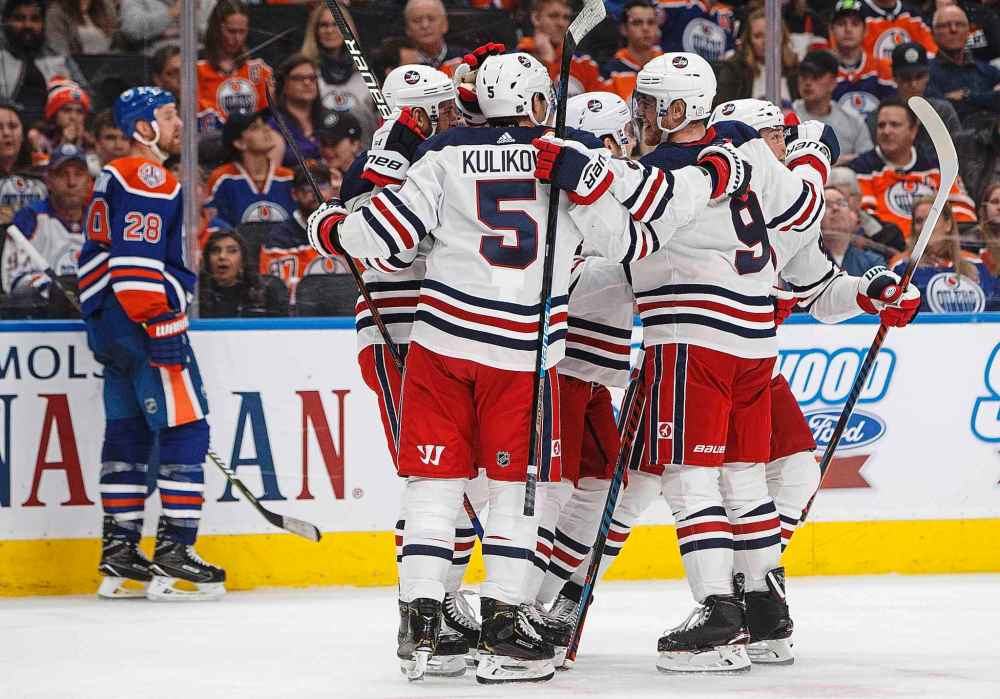 JASON FRANSON / THE CANADIAN PRESS
Winnipeg Jets celebrate a goal as Edmonton Oilers' Kyle Brodziak (28) skates past during the third period.