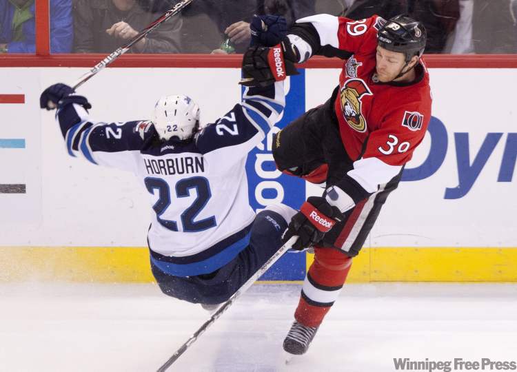 Adrian Wyld / THE CANADIAN PRESS
The Ottawa Senators' Matt Carkner collides with the Winnipeg Jets' Chris Thorburn during second period NHL action in Ottawa, on Monday.