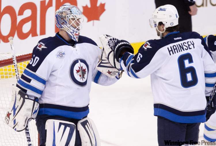 Adrian Wyld / THE CANADIAN PRESS
The Winnipeg Jets' Ron Hainsey congratulates goalie Chris Mason on the shutout as the Jets defeated the Senators 2-0 in Ottawa, on Monday.