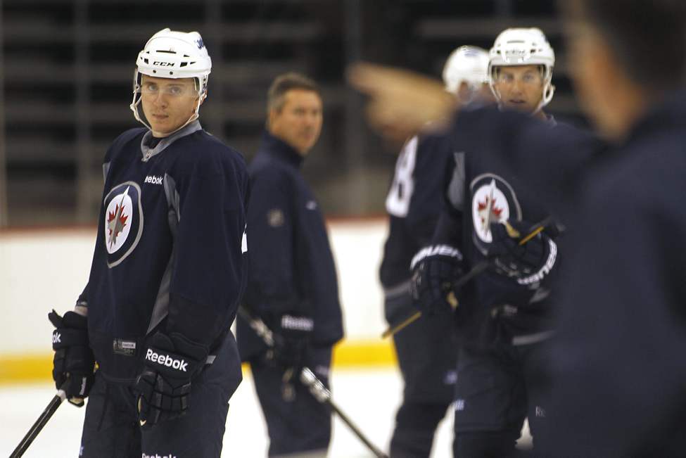 John Woods / Canadian Press Archives
Arturs Kulda listens to head coach Claude Noel on day two of the 2011 Jets training camp in Winnipeg in September 18. Kulda may be recalled to play for the Jets Sunday night.
