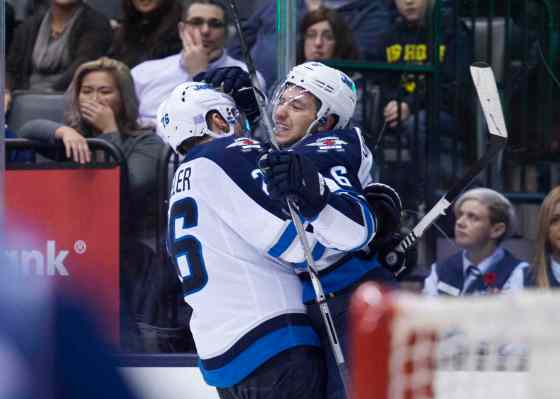 THE CANADIAN PRESS/Darren CalabreseWinnipeg Jets' Alexander Burmistrov, right, celebrates his game-winning goal with teammate Blake Wheeler during the third period.