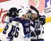 THE CANADIAN PRESS/Fred Chartrand
Winnipeg Jets' Andrew Ladd (16) celebrates his goal with teammates Toby Enstrom (39) and Blake Wheeler (26) during second period NHL hockey action, in Ottawa, on Thursday.