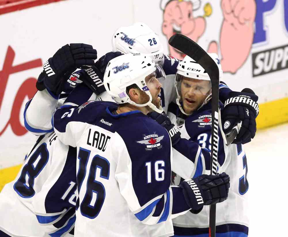 THE CANADIAN PRESS/Fred Chartrand
Winnipeg Jets' Andrew Ladd (16) celebrates his goal with teammates Toby Enstrom (39) and Blake Wheeler (26) during second period NHL hockey action, in Ottawa, on Thursday.
