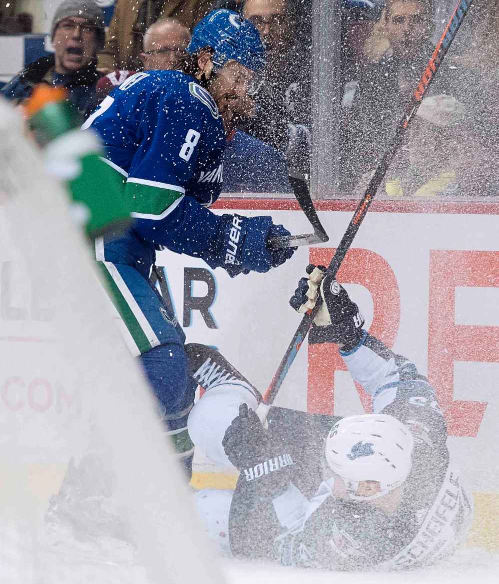 JONATHAN HAYWARD / THE CANADIAN PRESS
Vancouver Canucks defenceman Christopher Tanev (8) fights for control of the puck with Winnipeg Jets center Mark Scheifele (55) during first period NHL action at Rogers Arena in Vancouver, Saturday, Dec. 22, 2018.