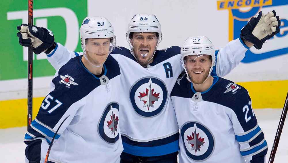 JONATHAN HAYWARD / THE CANADIAN PRESS
Winnipeg Jets center Mark Scheifele (55) celebrates his goal with teammates Tyler Myers (57) and Nikolaj Ehlers (27) during third period NHL action against the Vancouver Canucks at Rogers Arena in Vancouver, Saturday, Dec. 22, 2018.