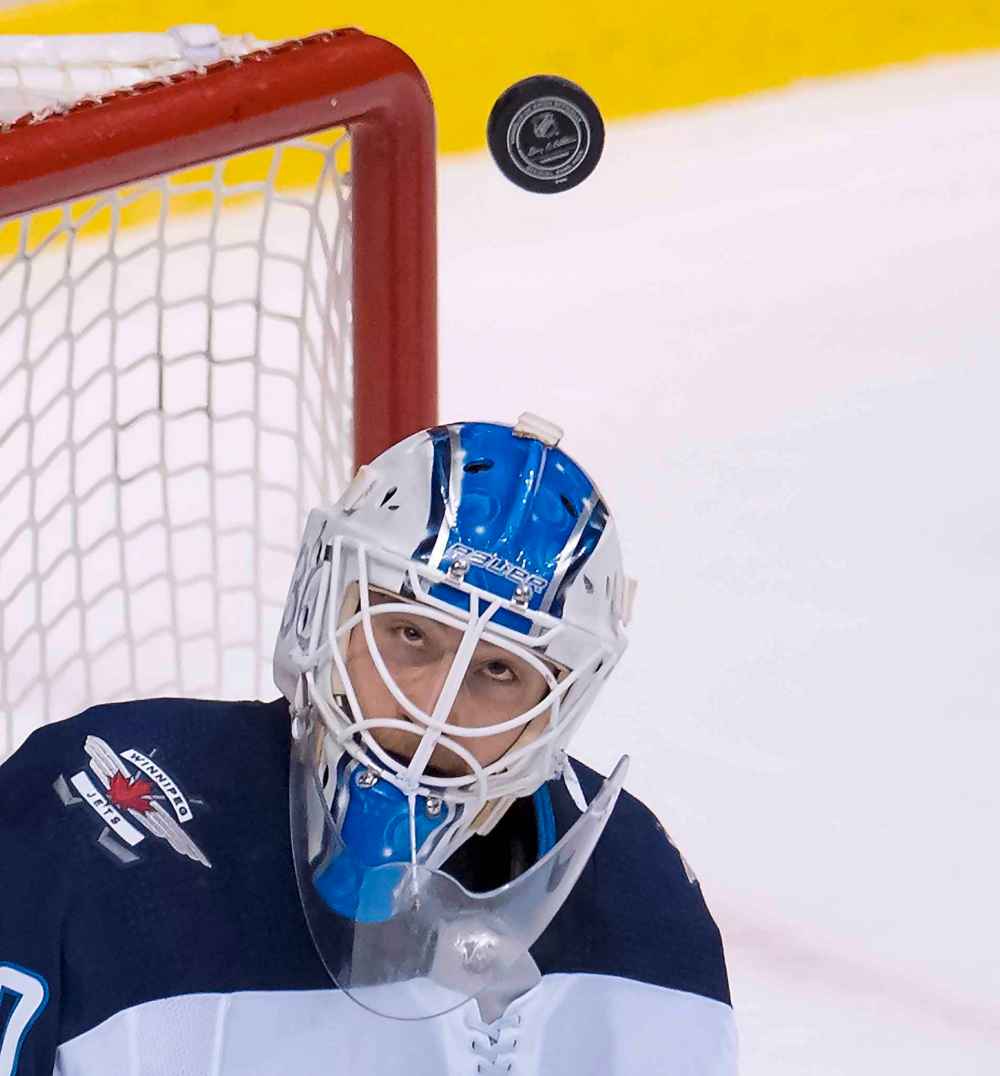 JONATHAN HAYWARD / THE CANADIAN PRESS
Winnipeg Jets goaltender Laurent Brossoit (30) keeps his eye on the puck during third period NHL action against the Vancouver Canucks at Rogers Arena in Vancouver, Saturday, Dec. 22, 2018.