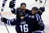 TREVOR HAGAN / THE CANADIAN PRESS
The Jets' Blake Wheeler (top) and Evander Kane (right) celebrate with Andrew Ladd after Ladd's shootout-winning goal Tuesday evening.