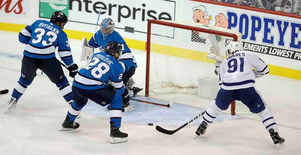 CP
John Tavares pops in the loose puck Wednesday as the Leafs beat the Jets 4-2. (Trevor Hagan / The Canadian Press)