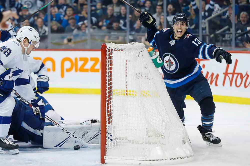 JOHN WOODS / THE CANADIAN PRESS
Winnipeg Jets' Brandon Tanev (13) celebrates after scoring against Tampa Bay Lightning's goaltender Andrei Vasilevskiy (88) during second period NHL action in Winnipeg on Sunday, Dec. 16, 2018.