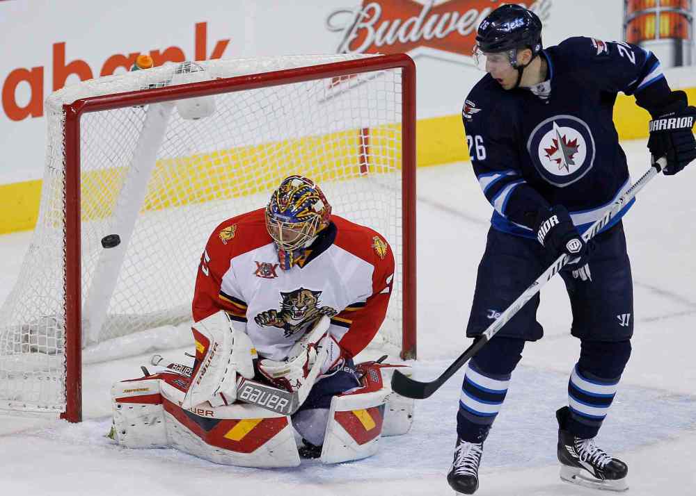 John Woods / The Canadian Press
Winnipeg Jets' Blake Wheeler (26) deflects the shot from the point for the goal agaist Florida Panthers goaltender Jacob Markstrom during first-period NHL action in Winnipeg on Friday.