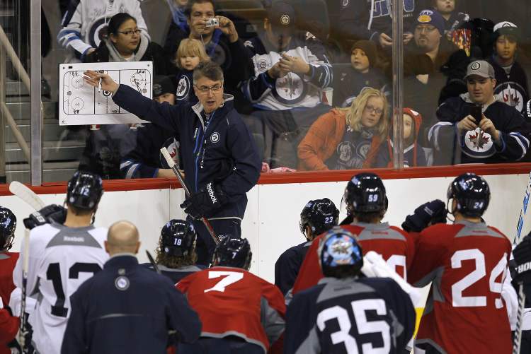 JOHN WOODS / WINNIPEG FREE PRESS
Winnipeg Jets head coach Claude Noel goes over some last-minute strategy at Friday's final training camp session.