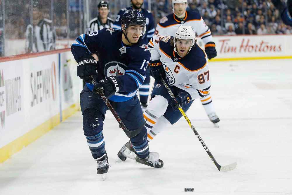 THE CANADIAN PRESS/John Woods
Edmonton Oilers' Connor McDavid chases down Winnipeg Jets' Brandon Tanev during the second period.