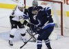 John Woods / The Canadian Press 
Pittsburgh Penguins' Steve Downie (23) and Winnipeg Jets' Mark Scheifele (55) watch Pens' Simon Despres' (47) shot just before it goes past Jets goaltender Ondrej Pavelec (31) during first period NHL action in Winnipeg on Thursday.