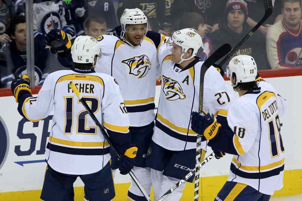 Trevor Hagan / THE CANADIAN PRESS
Predators Mike Fisher (left), Seth Jones, Patric Hornqvist and Michael Del Zotto celebrate Jones' first-period goal against the Jets at the MTS Centre Tuesday night.