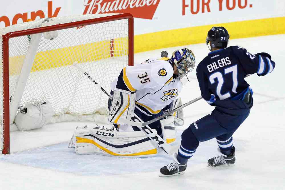 THE CANADIAN PRESS/John Woods
Winnipeg Jets' Nikolaj Ehlers (27) scores on Nashville Predators goaltender Pekka Rinne (35) during the first period.
