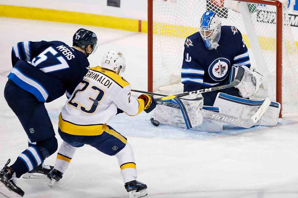 Laurent Brossoit made 35 saves Friday, including a handful that earned him standing ovations from the crowd and repeated chants of his name. (John Woods / The Canadian Press)