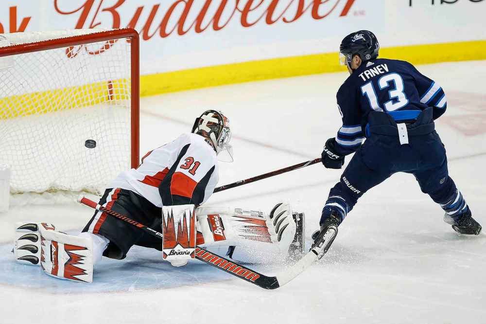 CP
JOHN WOODS / THE CANADIAN PRESS
Winnipeg Jets' Brandon Tanev (13) scores on Ottawa Senators goaltender Anders Nilsson (31) during first period NHL action.
