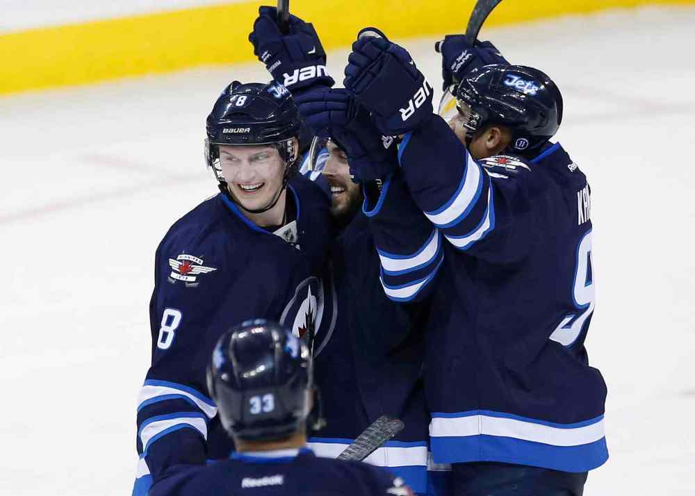 John Woods / the canadian press files
Winnipeg blue-liner Jacob Trouba (left) was in the thick of the action Wednesday night, helping to engineer Mathieu Perreault's winning goal in overtime.