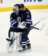 Trevor Hagan / The Canadian Press 
Winnipeg Jets goaltender Michael Hutchinson (34) and Tyler Myers (57) celebrate after defeating the Minnesota Wild 5-4 Sunday at the MTS Centre.