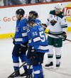 John Woods / The Canadian Press
Winnipeg Jets' Dustin Byfuglien (33) is assisted off the ice by Blake Wheeler (26) and Mark Scheifele (55) as Minnesota Wild's Mikko Koivu (9) looks on during third-period NHL action in Winnipeg on Saturday.