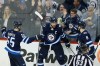 CP
Winnipeg Jets' Mark Scheifele (55), Blake Wheeler (26) and Jacob Trouba (8) celebrate Wheeler's game winning goal against the Minnesota Wild during third period NHL action in Winnipeg on Friday, October 20, 2017. THE CANADIAN PRESS/John Woods