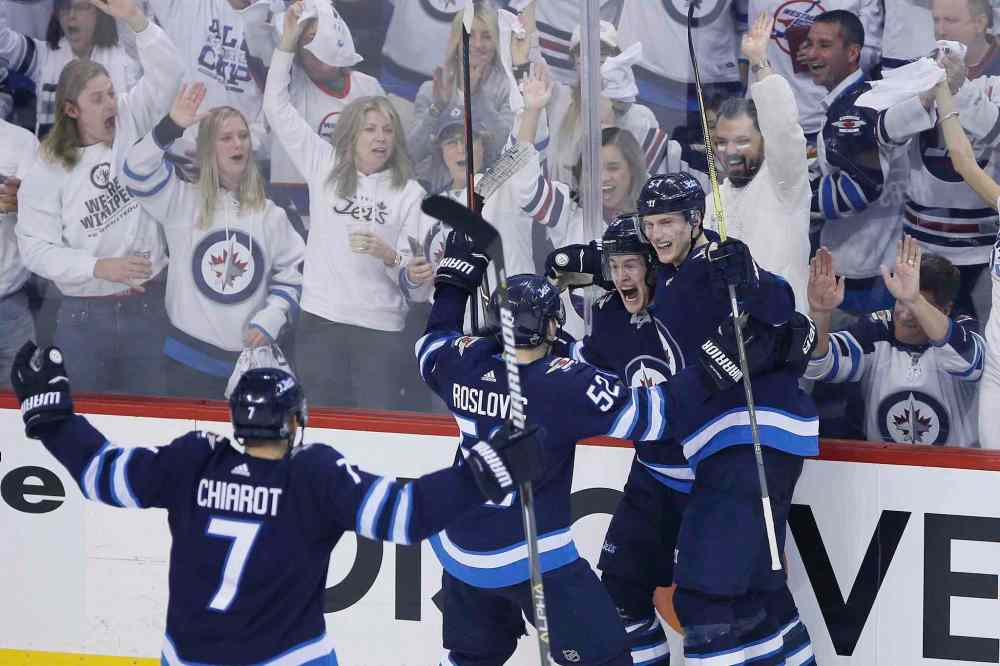 CP
JOHN WOODS / THE CANADIAN PRESS FILES
Winnipeg Jets' Ben Chiarot (7), Jack Roslovic (52), Andrew Copp (9) and Tyler Myers (57) celebrate Copp's goal against the Minnesota Wild during third period game two NHL playoff action in Winnipeg on Friday. The Jets, who lead the series 2-0, and hoping for a third win tonight against the Wild in Saint Paul.