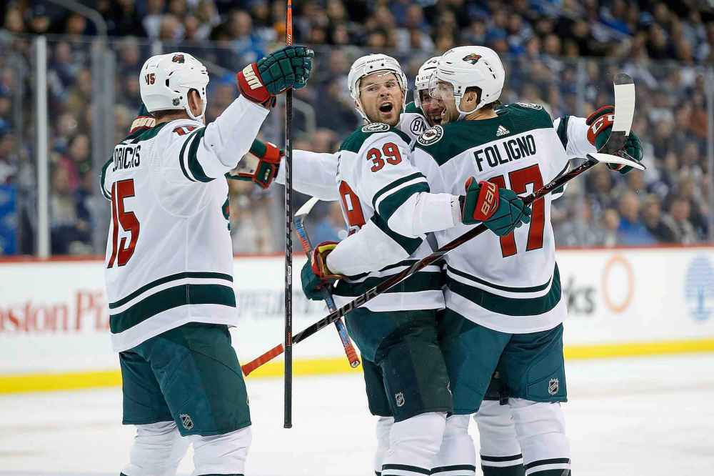 JOHN WOODS / THE CANADIAN PRESS
Minnesota Wild's Matt Hendricks (15), Nate Prosser (39), Matt Bartkowski (44) and Marcus Foligno (17) celebrate Bartkowski's goal against the Winnipeg Jets during first period NHL action in Winnipeg on Saturday, December 29, 2018.