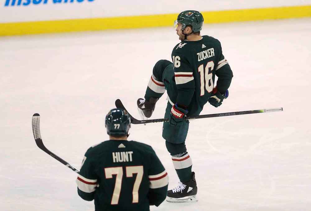 Brad Hunt and Jason Zucker celebrate after Zucker scored late in the third period to tie the game 2-2. (Trevor Hagan / The Canadian Press)