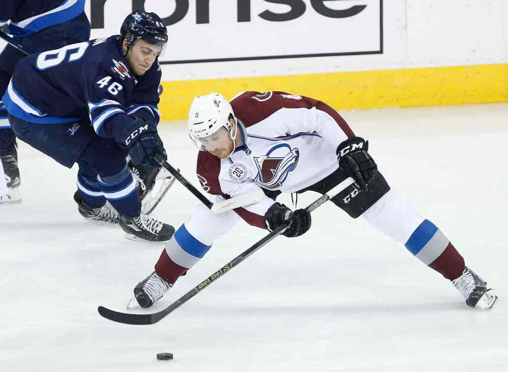 John Woods / WINNIPEG FREE PRESS
Winnipeg Jets' J.C. Lipon (46) reaches out to Colorado Avalanche's Jack Skille (8) during first period NHL action in Winnipeg on Monday.