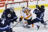 John Woods / WINNIPEG FREE PRESS files
Jets goalie Ondrej Pavelec looks back as the Flyers’ Chris VandeVelde rings a shot off the crossbar Sunday. Jets winger Chris Thorburn (22) charges back to defend.