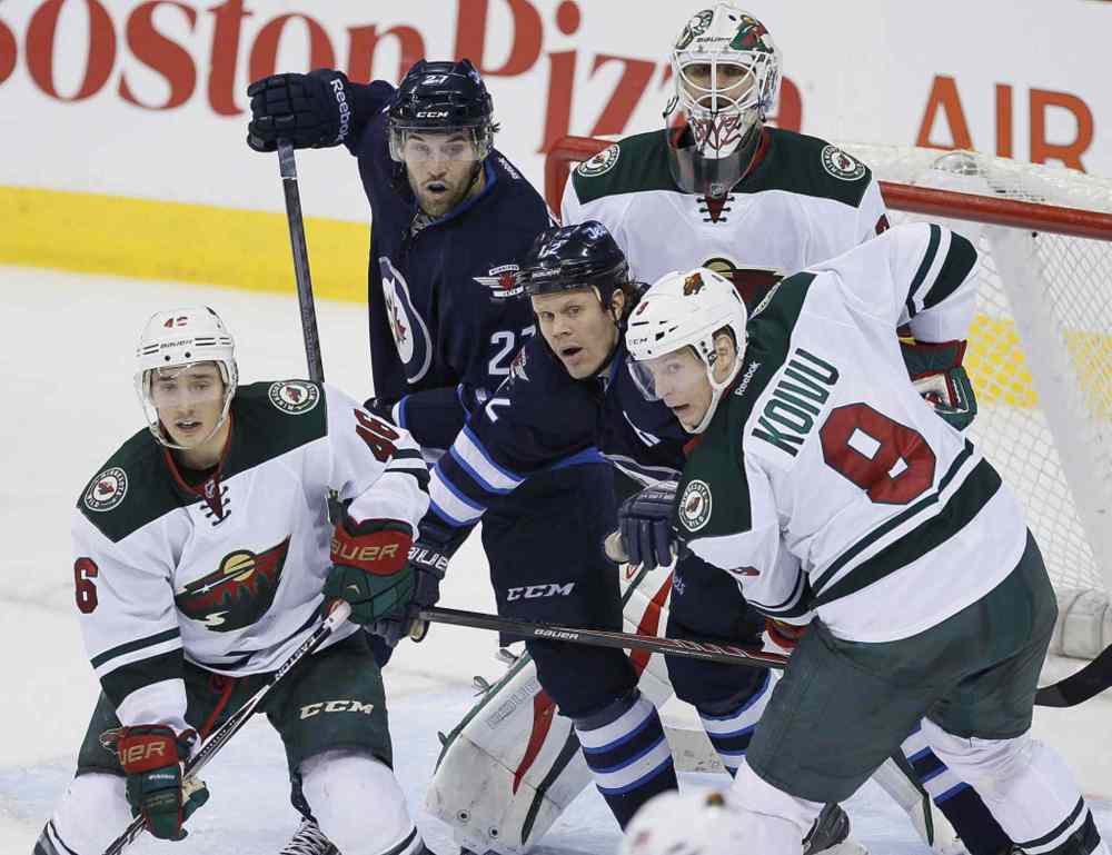 JOHN WOODS / WINNIPEG FREE PRESS
Winnipeg Jets' Eric Tangradi (27) and Olli Jokinen (12) fight for position with Minnesota Wild's Jared Spurgeon (46) and Mikko Koivu (9) in front of goaltender Ilya Bryzgalov (30) during third period NHL action in Winnipeg on Monday.