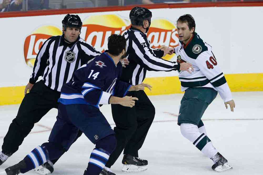 John Woods / WINNIPEG FREE PRESS Files
Minnesota Wild's Curt Gogol (40) and Winnipeg Jets' Anthony Peluso (14) try to get around refs during a pre-season game in Winnipeg on Sept. 22.