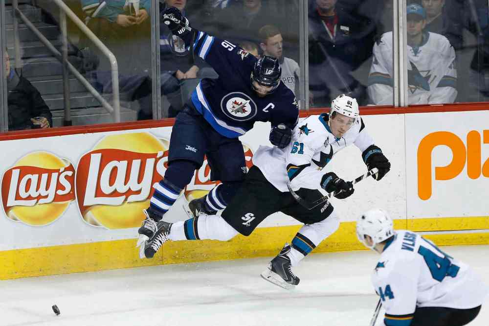 John Woods / WINNIPEG FREE PRESS
Winnipeg Jets' Andrew Ladd (16) hits San Jose Sharks' Justin Braun (61) as Marc-Edouard Vlasic (44) looks on during first period NHL action in Winnipeg on Tuesday.