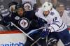 John Woods / Winnipeg Free Press 
Winnipeg Jets defenceman Johnny Oduya absorbs a hit from Toronto Maple Leafs forward Mike Brown during the first period Tuesday  night at the MTS Centre.